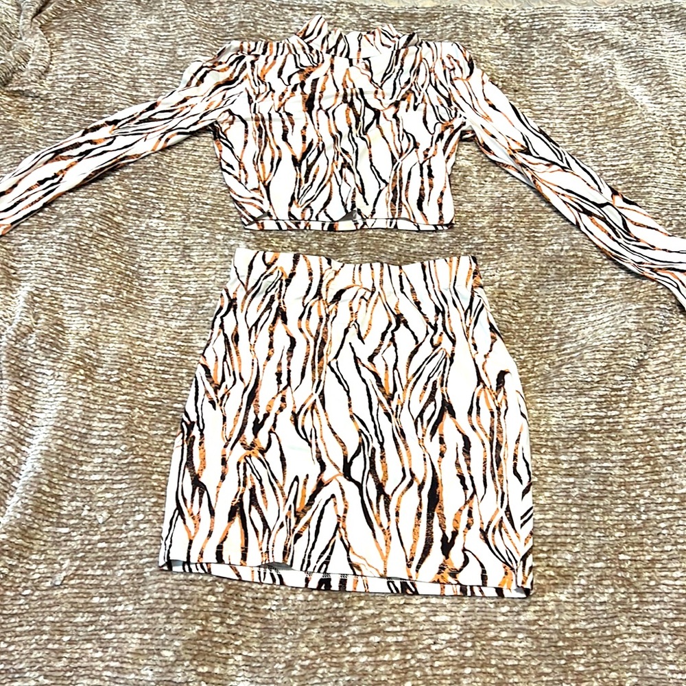 2 piece white with brown and blacked striped skirt outfit.